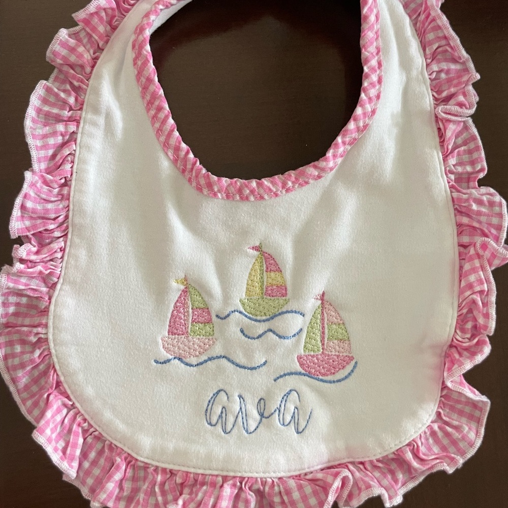 “Ava” Pink and White Sailboat Embroidered Baby Bib with gingham ruffle detail